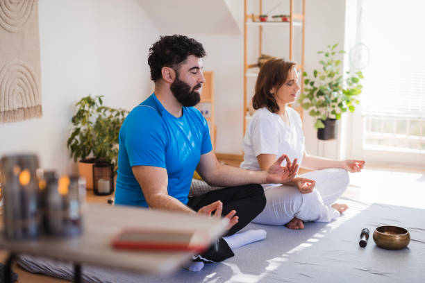 istock Man and woman meditating together 2035405083