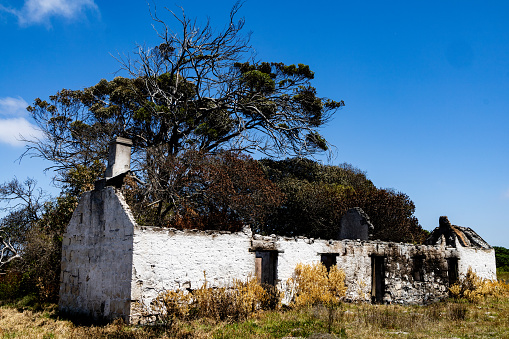 The ruins of an old farmhouse in the Agulhas area of South Africa after a fire destroyed the roof and blackened the walls.