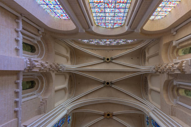 Grand view of ornately crafted Gothic-style cathedral vaults. The architectural details highlight the craftsmanship, with natural light enhancing the texture and height of the structure in Bordeaux, France.