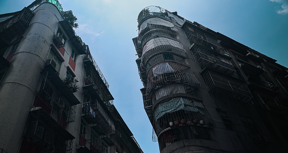 A photo depicting a pair of tall buildings situated adjacent to each other in the bustling city of Macau.