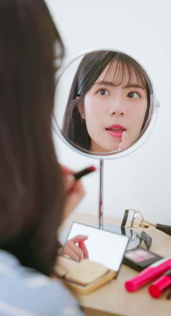 asian businsswoman doing makeup