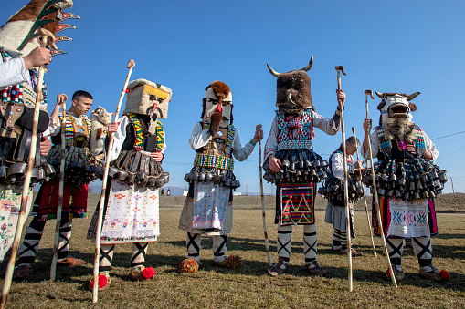 Elin Pelin, Bulgaria - February 17, 2024: Eighth edition of masquerade festival in Elin Pelin Bulgaria. Men dressed in kuker costume with copper bells perform a ritual for fertility and health.