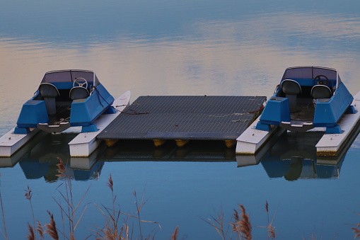 pedal boats moored on the shore