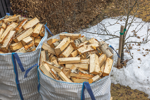 Top view of transport bags with birch firewood on a winter-spring day. Sweden.