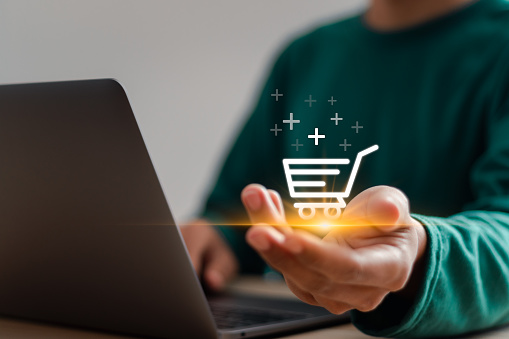 E-commerce concept. Businessman use laptop online shopping to digital cart with ecommerce global network connection. ecommerce store, online business, convenience, competitive price.