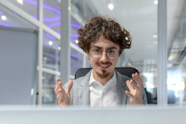 istock Confident young businessman with curly hair engaged in office work discussion 2035493801