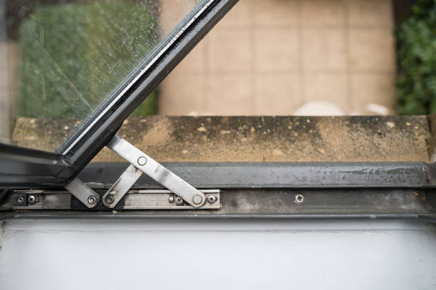 Top down, abstract view of a first floor hotel window seen opened. The hinge system can be seen.