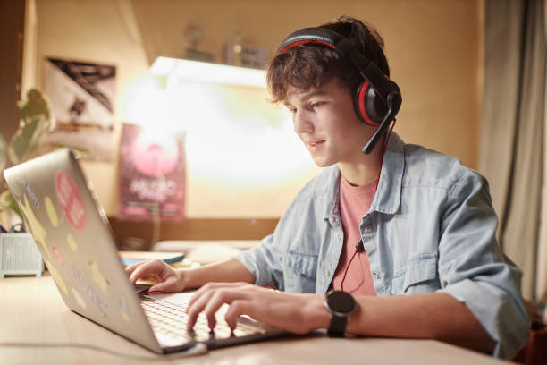istock Teenage Boy Playing Video Games with Headset 2035506869