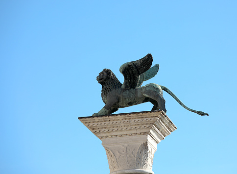 statue of the winged lion of saint mark symbol of the city of venice in northern italy on the column