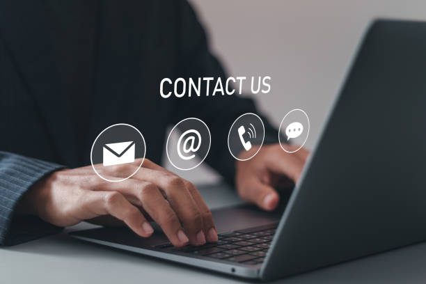 istock Customer support center contact us. Businessman using computer laptop with contact icons on virtual screen for customer support hotline and people connection. 2035513999