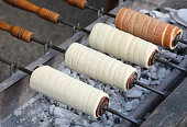 Trdelník also called trozkol is a kind of spit cake of East Europe slow cooked over glowing embers and served hot with grains of dried fruit
