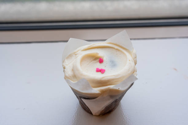 Closeup chocolate cupcake with a vanilla buttercream frosting.