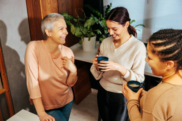 istock Three women standing in the kitchen, drinking coffee 2035540318