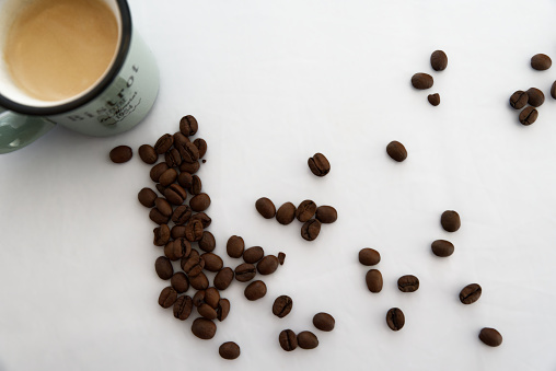 Cup of coffee and coffee bean on white background