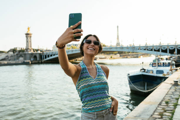 istock Millennial tourist in PAris, taking selfie with Eiffel tower in the background 2035566207