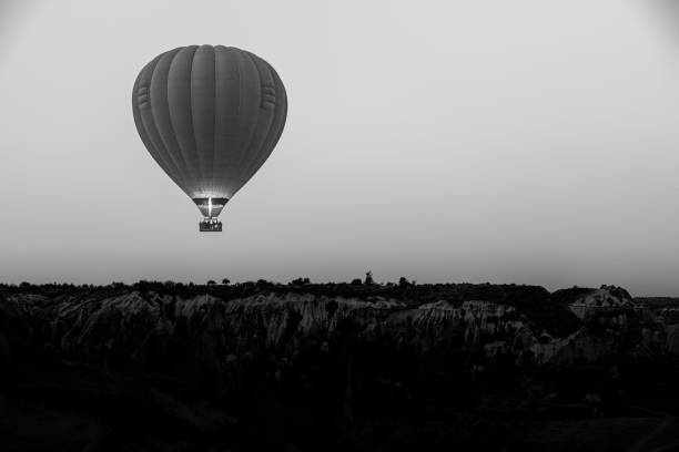 Hot air balloon morning fly over the rocks Cappadocia/Turkey - September 16 2017: Hot air balloon morning fly over the rocks black and white balloons stock pictures, royalty-free photos & images