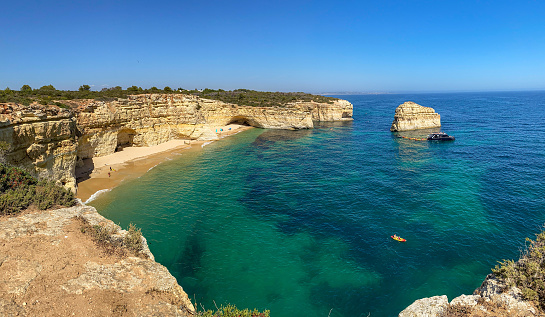 View to coastline with beautiful and sunny portuguese beach Praia da Marinha near Lagoa in summer, Algarve Portugal