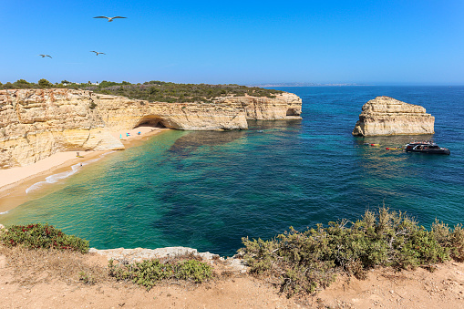 View to coastline with beautiful and sunny portuguese beach Praia da Marinha near Lagoa in summer, Algarve Portugal