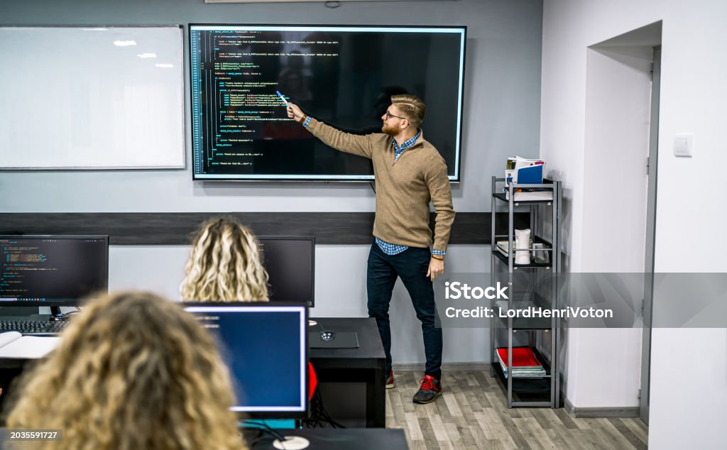 Male Instructor Teaching In A Programming School Stock Photo - Download ...