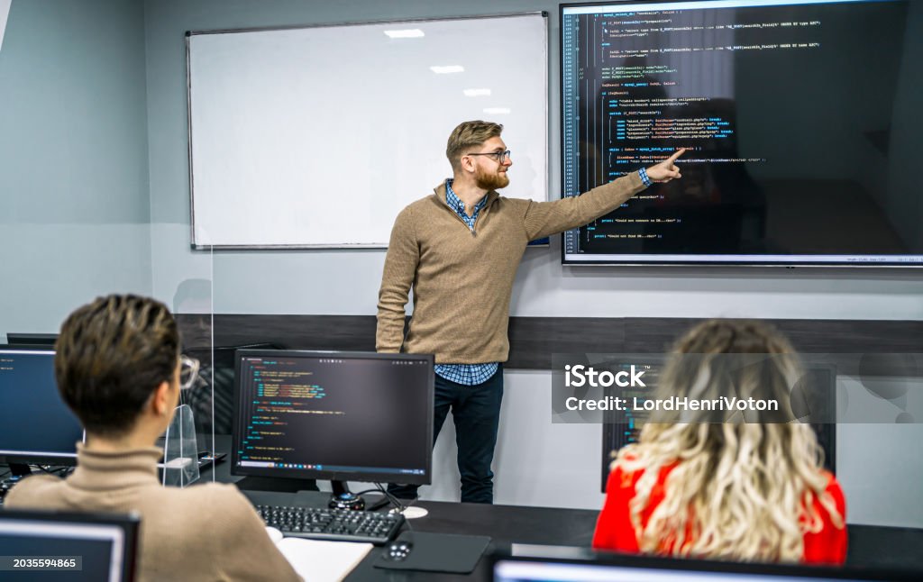 Male Instructor Teaching In A Programming School Stock Photo - Download ...