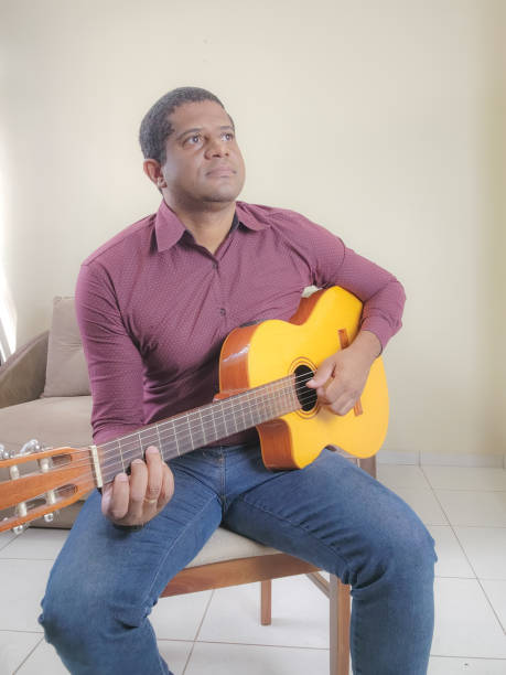 Music student playing cello and guitar instrument