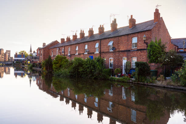 istock Red-brick terraced houses along a canal at sunset 2035628849