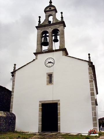 Santiago  church facade and bell tower,  low angle front view, Boente, camino de Santiago, A Coruña province, Galicia, Spain.
