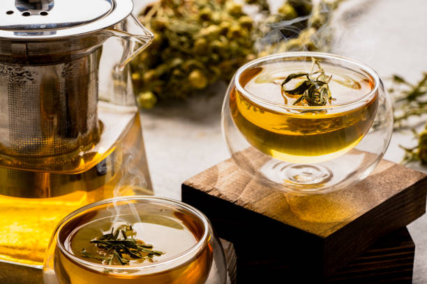 istock Glass of tea or herbal tea on white stone background 2035652731