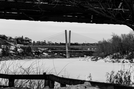 Edmonton, Canada - Frozen North Saskatchewan River with view on Tawatina LRT Bridge