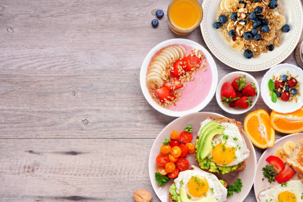 istock Healthy breakfast or brunch side border on a wood background. Top view. 2035667606