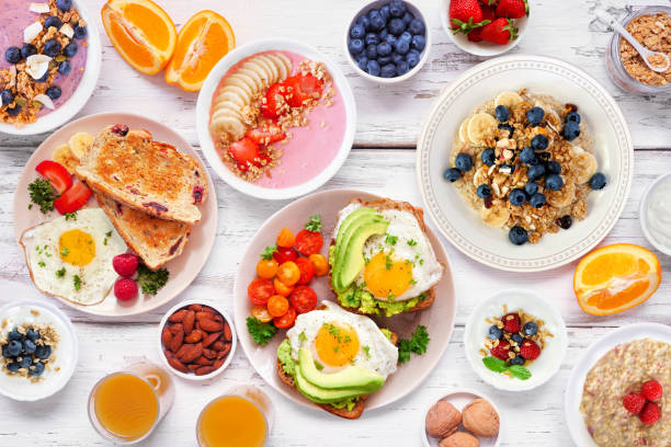 istock Healthy breakfast or brunch table scene on a white wood background. Overhead view. 2035669260