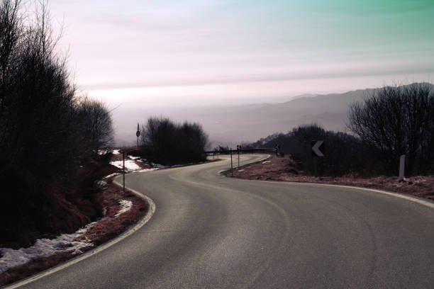 A wandering road in the mountain vegetation, whit a breathtaking view of the lake. Mottarone mountain (Omegna side) - Piedmont - Italy.