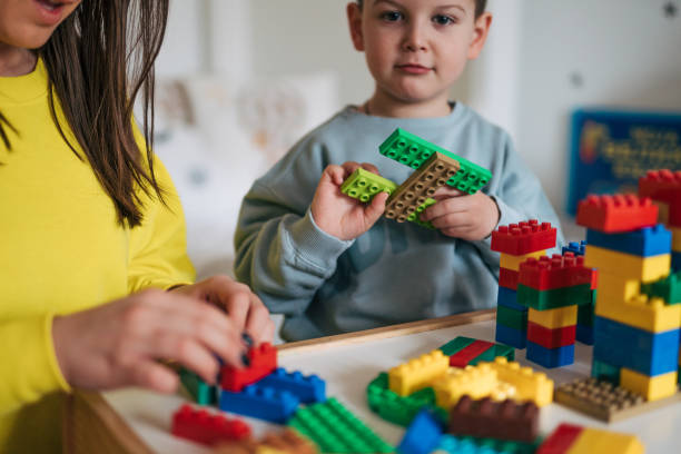 istock A little boy spends time with his mother and plays with blocks. 2035720616