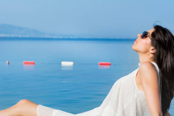 Young woman relaxing on a sea background
