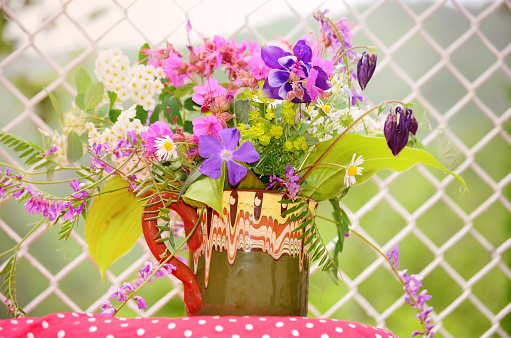 Vase with colorful wild spring flowers