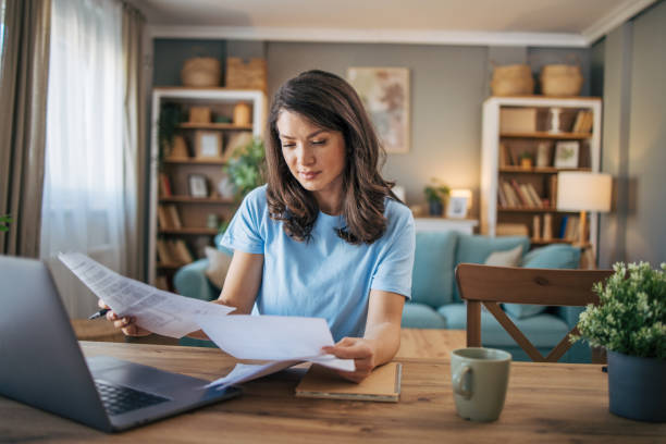 istock Adult woman analyzing bills. 2035793501