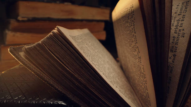 istock Opened saved medieval book with ancient writings. Religious literature, archival manuscripts, rare collection tomes, artifacts. 2035806464
