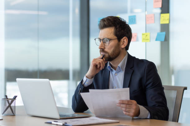 istock Focused senior businessman analyzing documents in modern office - corporate executive 2035822727