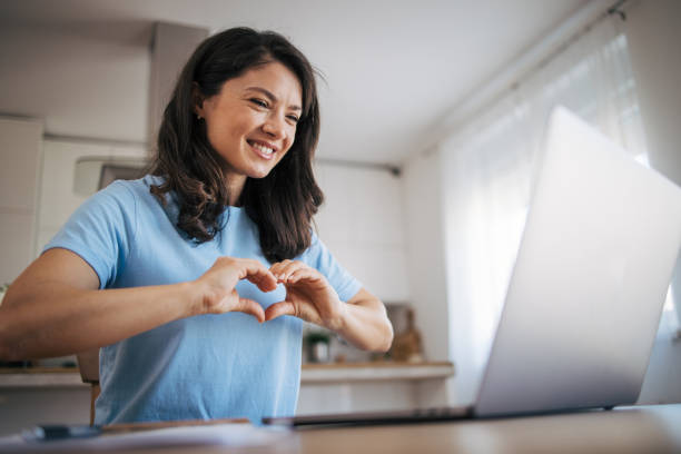 istock beautiful woman make a heart with your hands. 2035824295
