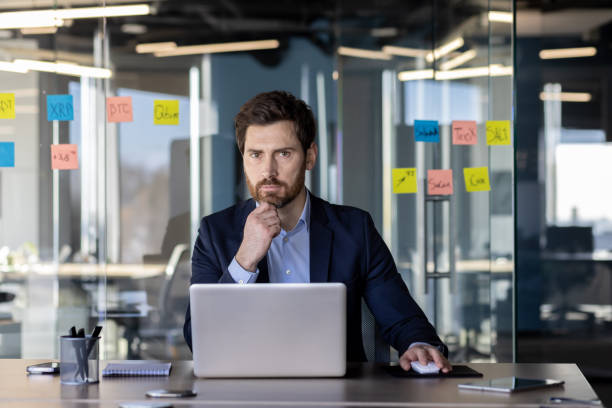 istock Serious businessman analyzing financial strategies in modern office space 2035826874