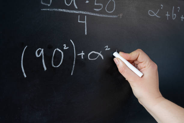istock woman writing with chalk a mathematics formula on a blackboard 2035842594