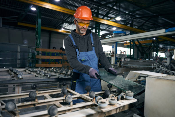 istock Master in a window production processes the edges of glass 2035857213