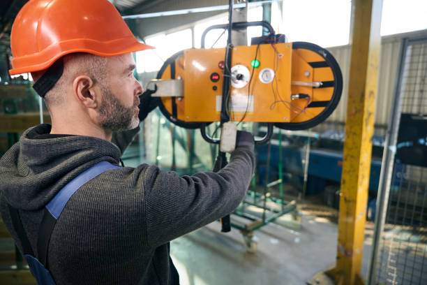 istock Foreman uses a vacuum lifting device in a window production 2035858322
