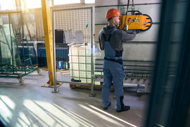 istock Foreman uses a vacuum lifting device in a production workshop 2035858326