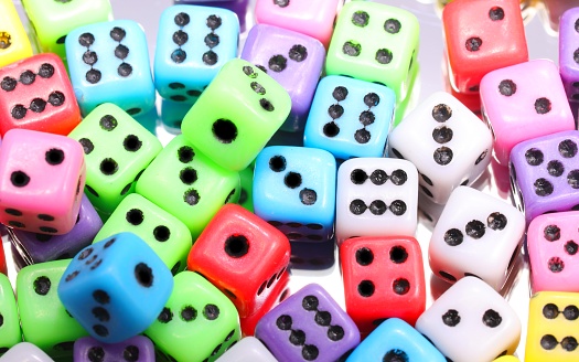 background of many mini cubic six-sided gaming dice rolled for playing