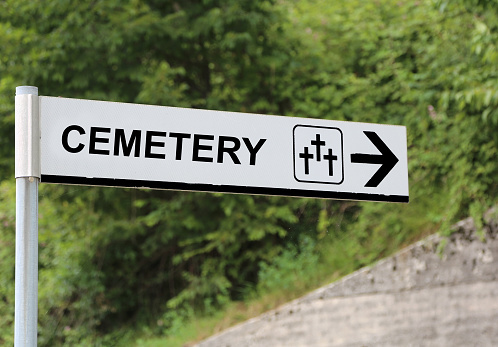 large text CEMETERY with the arrow to reach the holy field on the hill
