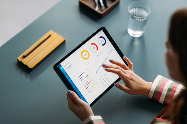 istock Professional Woman Analyzing Financial Charts on Digital Tablet 2035915095