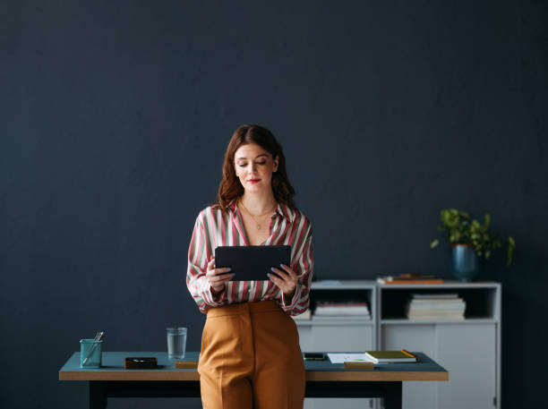 Professional Woman Using Tablet in Contemporary Office Setting