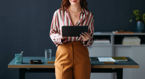 istock Confident Businesswoman Standing with Tablet in Modern Office 2035915107