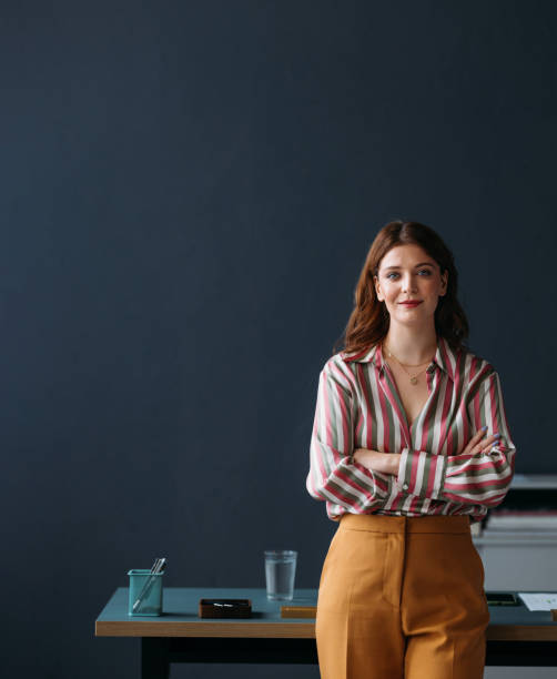 istock Confident Professional Woman in Striped Shirt Posing at Workplace 2035915111